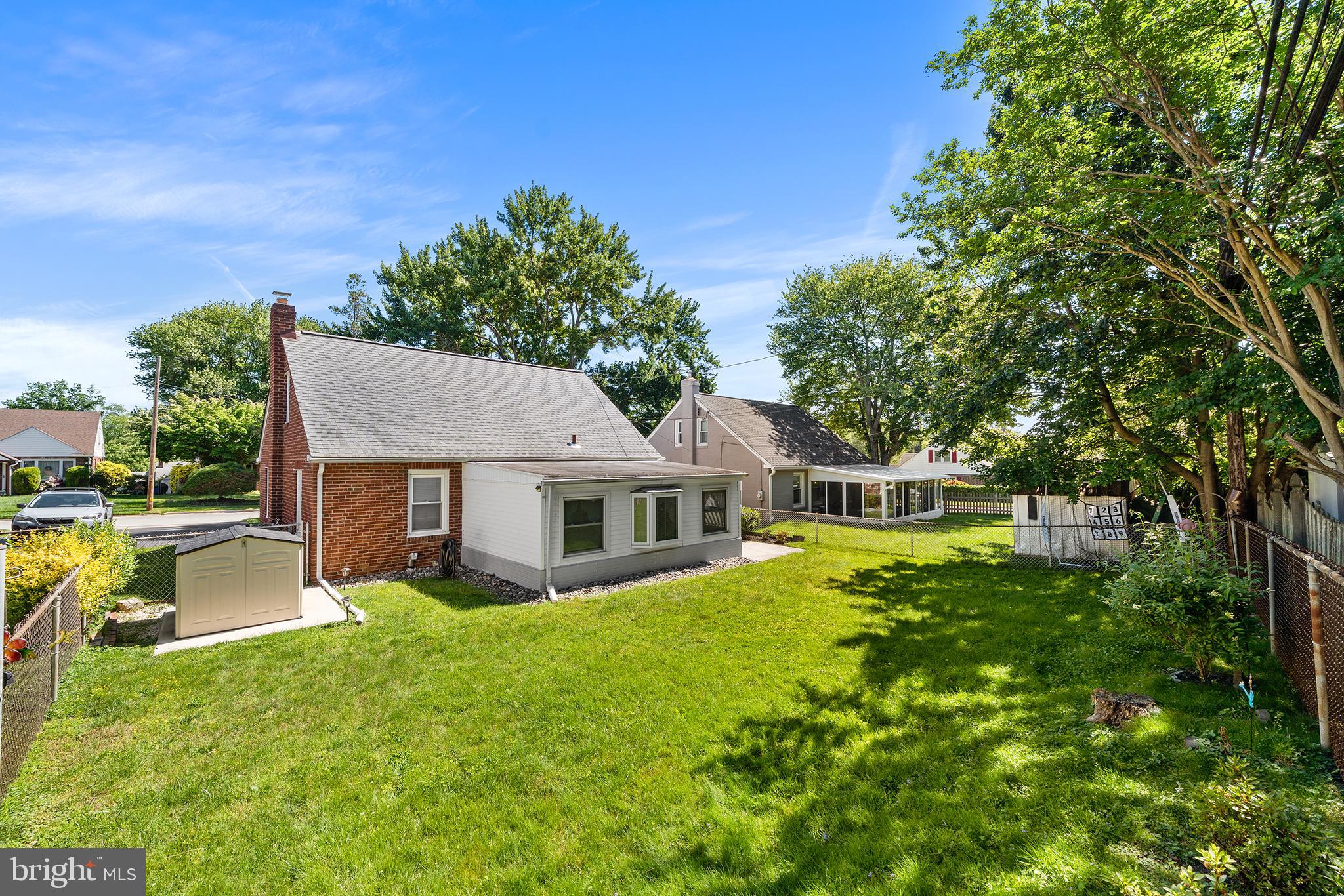 504 Lawrence Road Havertown, PA 19083 - Photo 5 of 20 a view of a house with a big yard potted plants and large tree