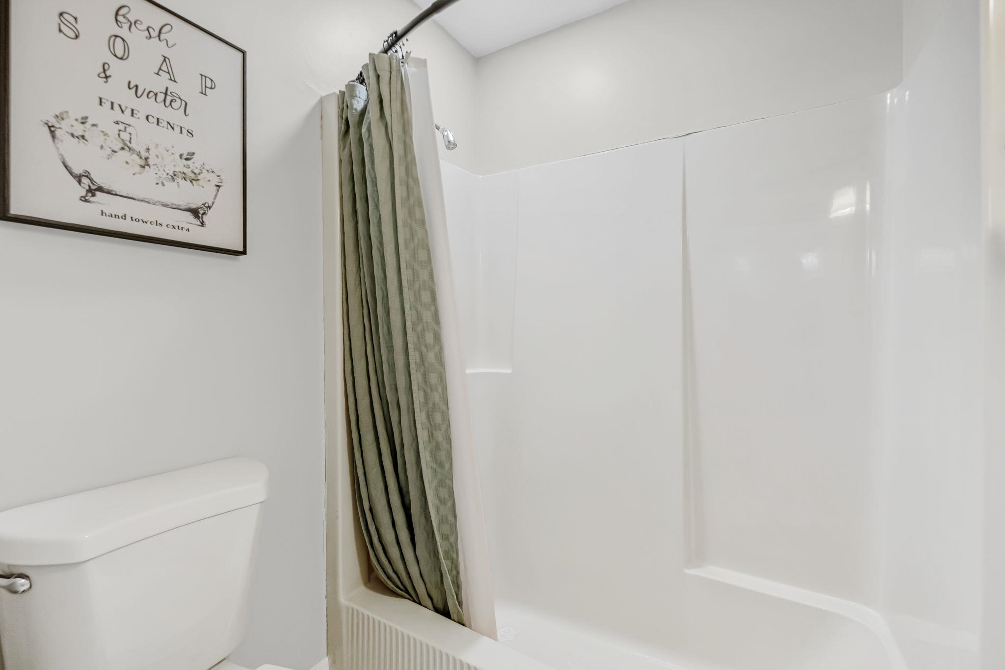 4729 Cedar Ridge Drive Millington, TN 38053 - Photo 27 of 40 White acrylic tub and shower combination with a curved shower curtain rod