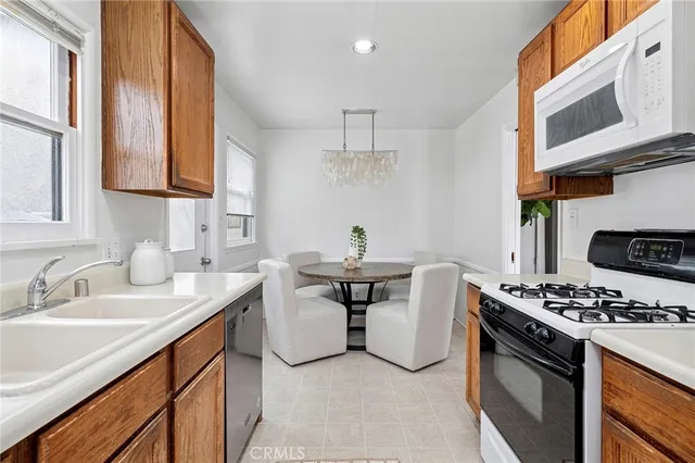 a kitchen with stainless steel appliances a sink a stove and cabinets
