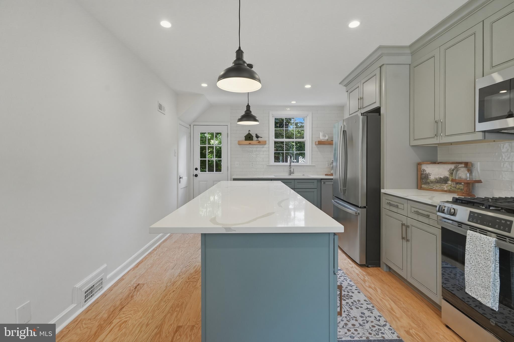 800 Pleasant Hill Road Wallingford, PA 19086 - Photo 6 of 34 a kitchen with stainless steel appliances granite countertop a sink a stove a refrigerator cabinets and a dining table