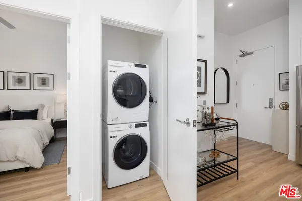 a view of a bedroom with washer and dryer