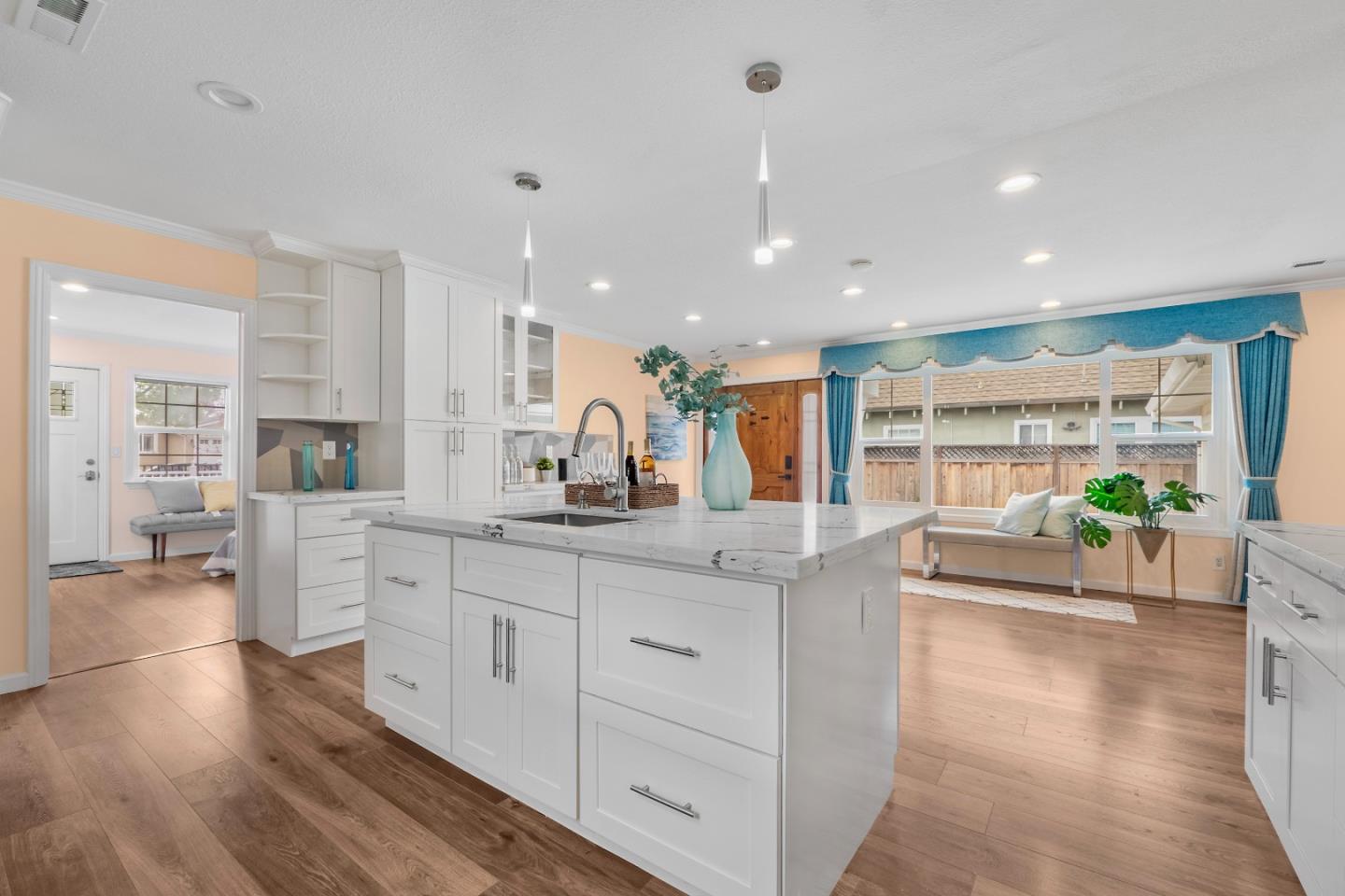 983 Smith Avenue Campbell, CA 95008 - Photo 1 of 57 a large kitchen with kitchen island a large counter top space a sink a refrigerator and a large window