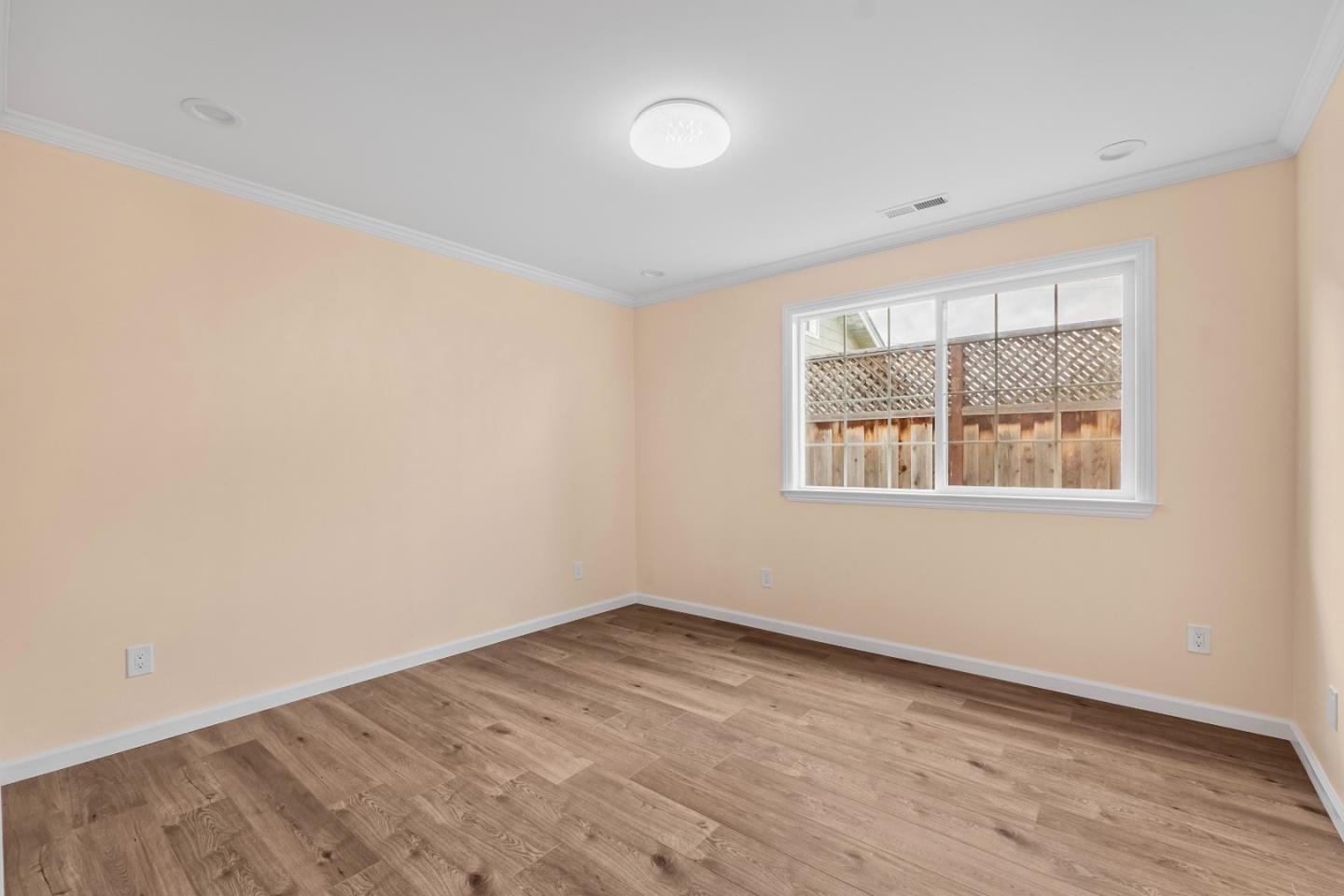 983 Smith Avenue Campbell, CA 95008 - Photo 28 of 57 an empty room with wooden floor and windows