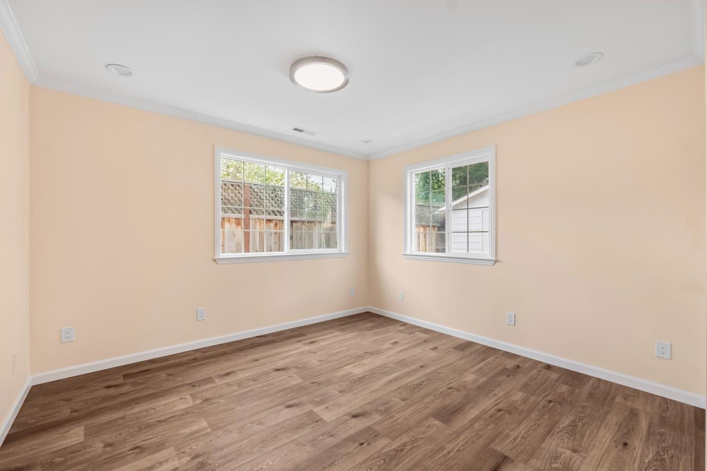 983 Smith Avenue Campbell, CA 95008 - Photo 30 of 57 an empty room with wooden floor and windows