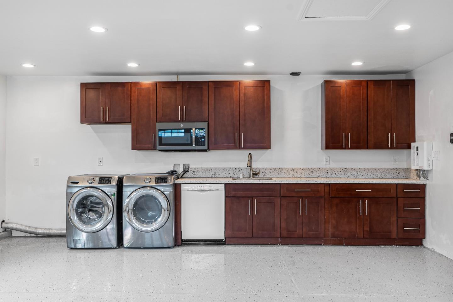 983 Smith Avenue Campbell, CA 95008 - Photo 38 of 57 a kitchen with kitchen island granite countertop a sink and a stove