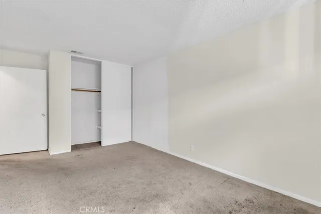 a view of a room with a wooden floor and a window