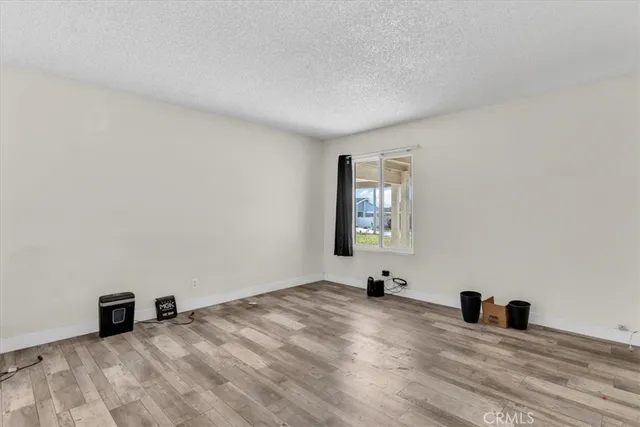 a view of wooden floor and cabinet in a room