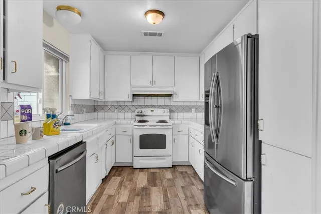 a kitchen with a white cabinets and white appliances