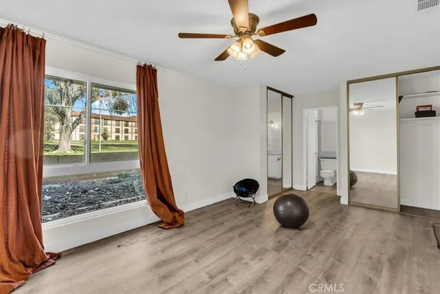 a view of a livingroom with a ceiling fan and window