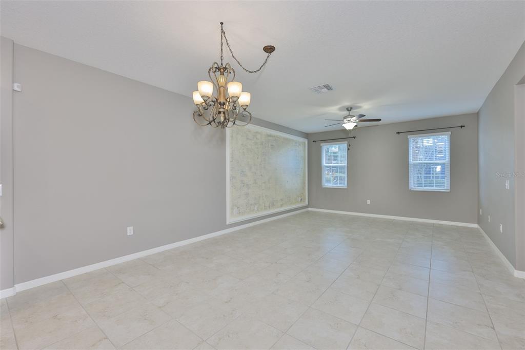 6330 Lantern View Place Apollo Beach, FL 33572 - Photo 12 of 64 a view of a chandelier fan and windows in an empty room