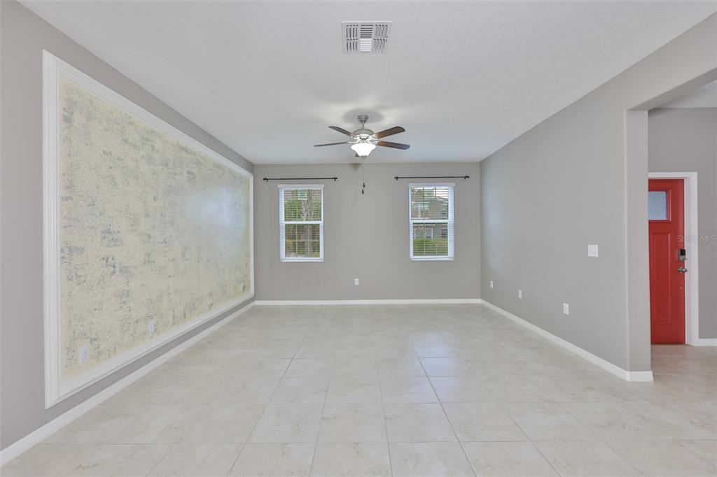 6330 Lantern View Place Apollo Beach, FL 33572 - Photo 13 of 64 an empty room with windows and ceiling fan