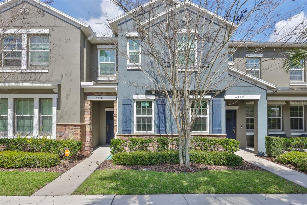 6330 Lantern View Place Apollo Beach, FL 33572 - Photo 2 of 64 front view of a brick house with a yard