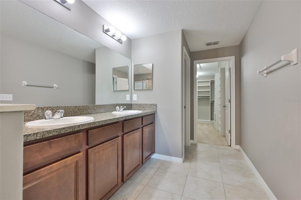 6330 Lantern View Place Apollo Beach, FL 33572 - Photo 25 of 64 a bathroom with a granite countertop sink and a mirror