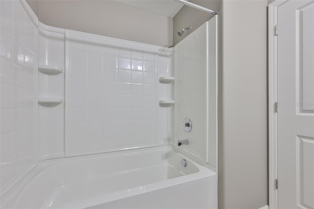 6330 Lantern View Place Apollo Beach, FL 33572 - Photo 32 of 64 a white bath tub sitting next to a shower