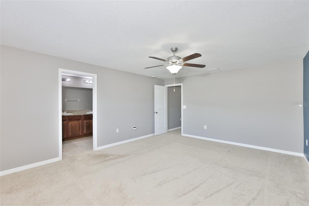 6330 Lantern View Place Apollo Beach, FL 33572 - Photo 35 of 64 a view of an empty room with a chandelier fan