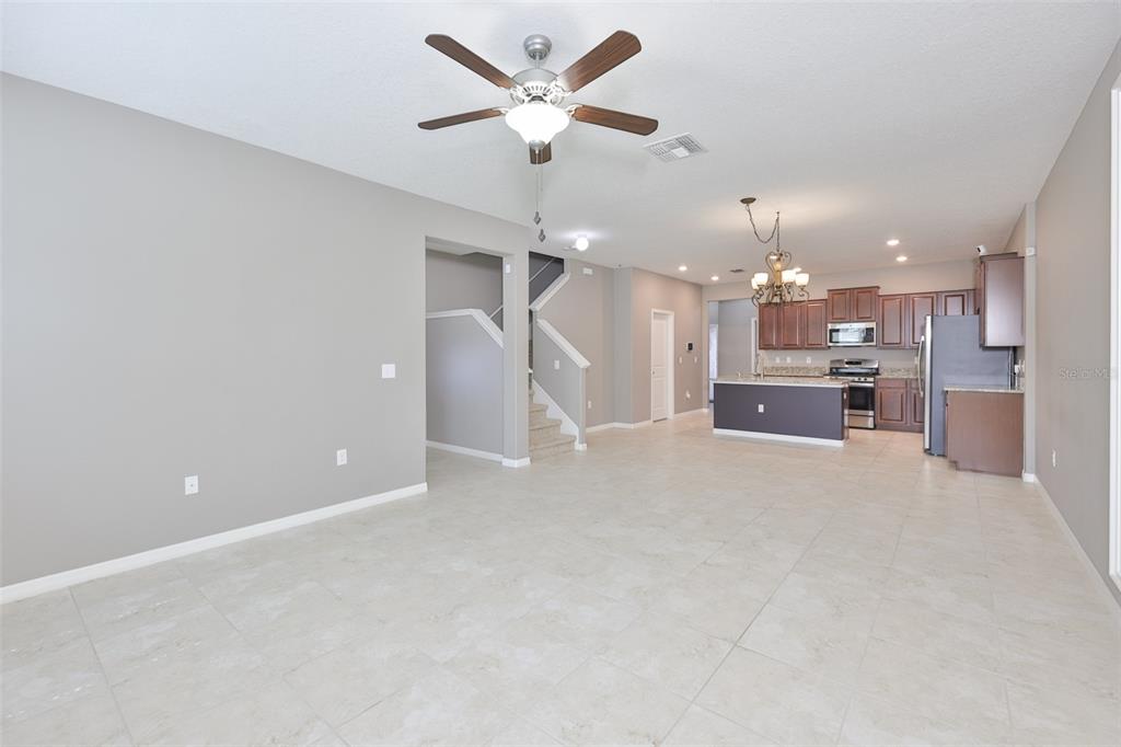 6330 Lantern View Place Apollo Beach, FL 33572 - Photo 5 of 64 an open kitchen with refrigerator and ceiling fan