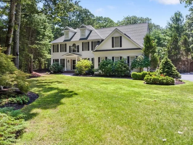 a front view of house with yard and green space