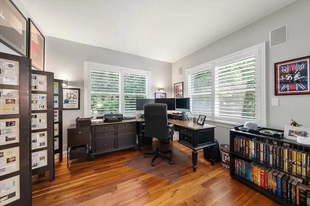 a view of a livingroom with workspace and a window