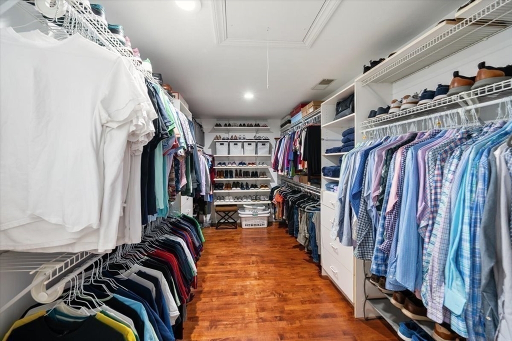 15 A Moccasin Path Natick, MA 01760 - Photo 14 of 42 a view of walk in closet with clothes and shoes
