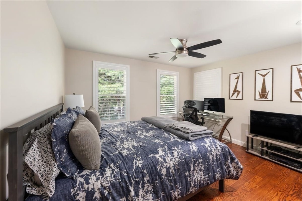 15 A Moccasin Path Natick, MA 01760 - Photo 16 of 42 a bedroom with a bed and a flat screen tv