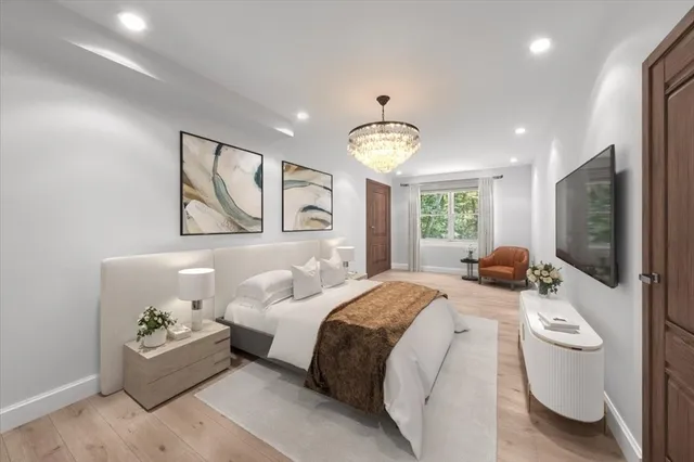 a spacious bedroom with a bed window and couch