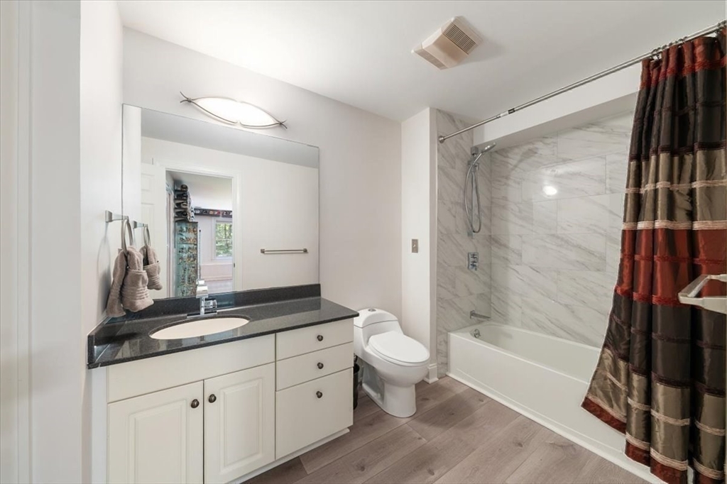 15 A Moccasin Path Natick, MA 01760 - Photo 26 of 42 a bathroom with a double vanity sink a toilet a mirror and shower