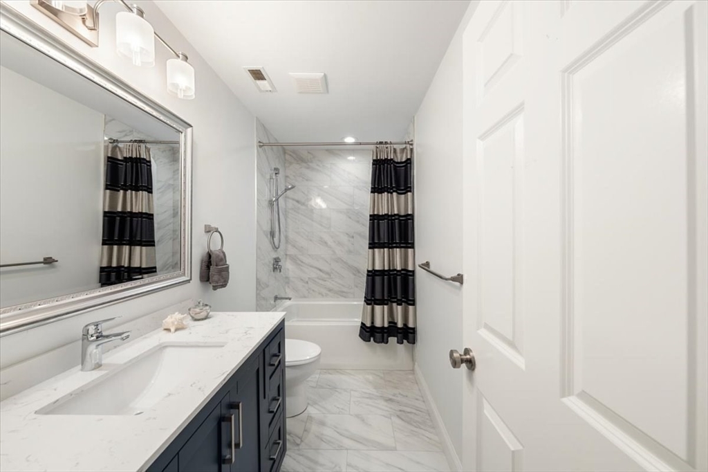 15 A Moccasin Path Natick, MA 01760 - Photo 27 of 42 a bathroom with a sink and mirror