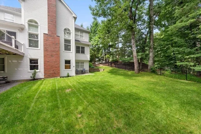 a view of a brick house with a yard
