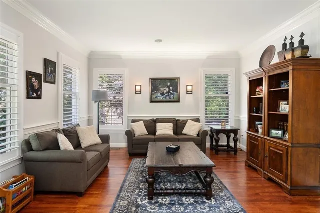 a living room with furniture flat screen tv and a window