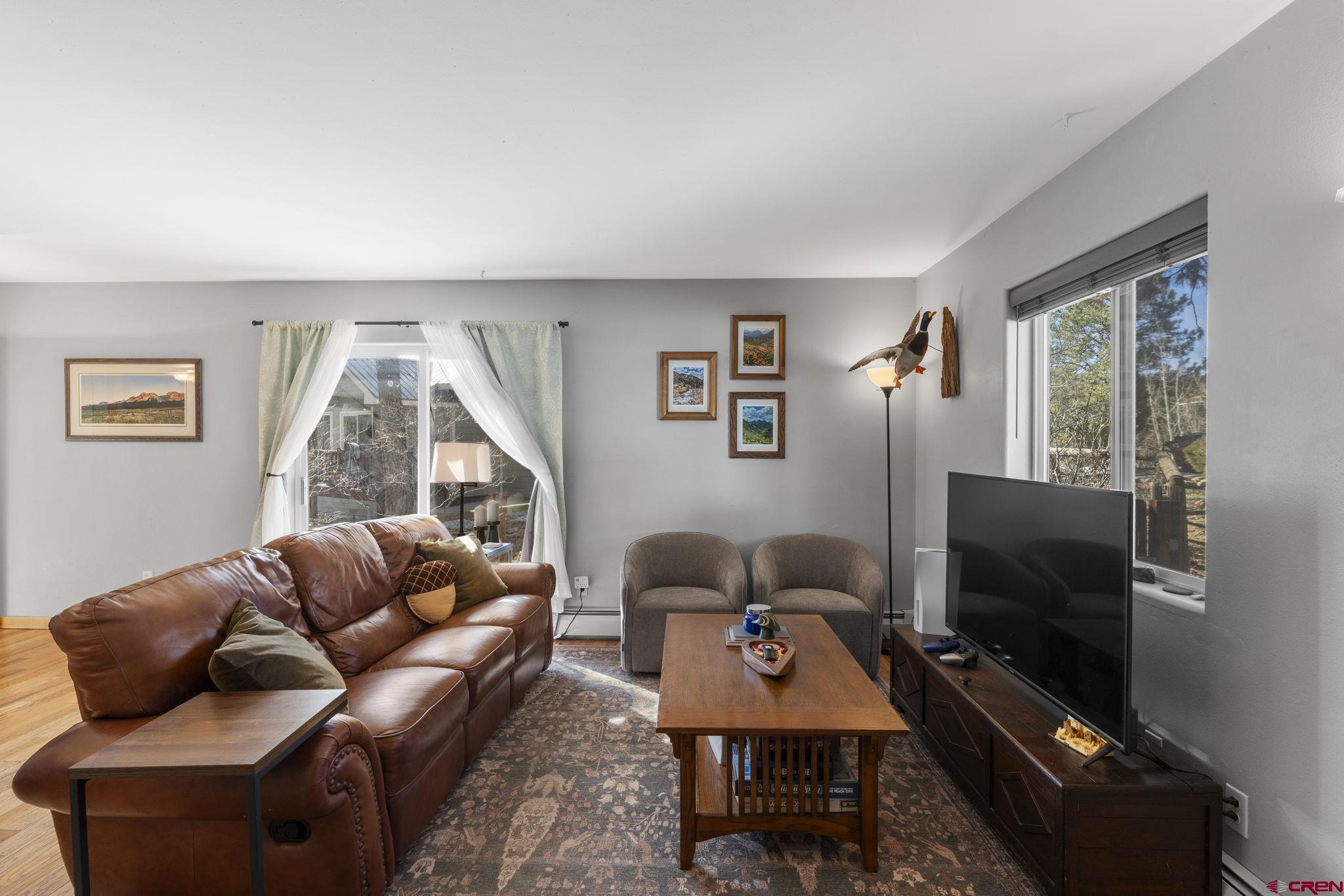 31 Valley View Way Durango, CO 81303 - Photo 4 of 29 a living room with furniture a flat screen tv and a window