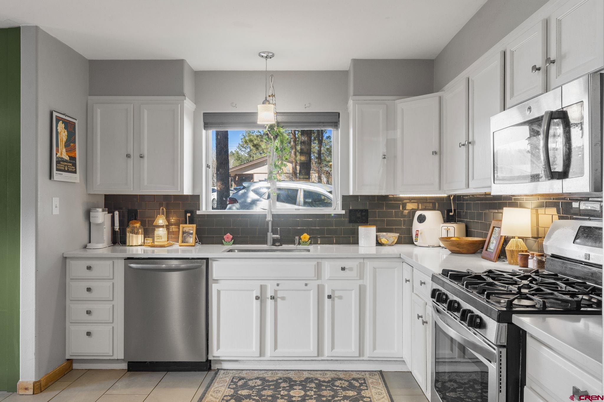 31 Valley View Way Durango, CO 81303 - Photo 9 of 29 a kitchen with white cabinets and appliances