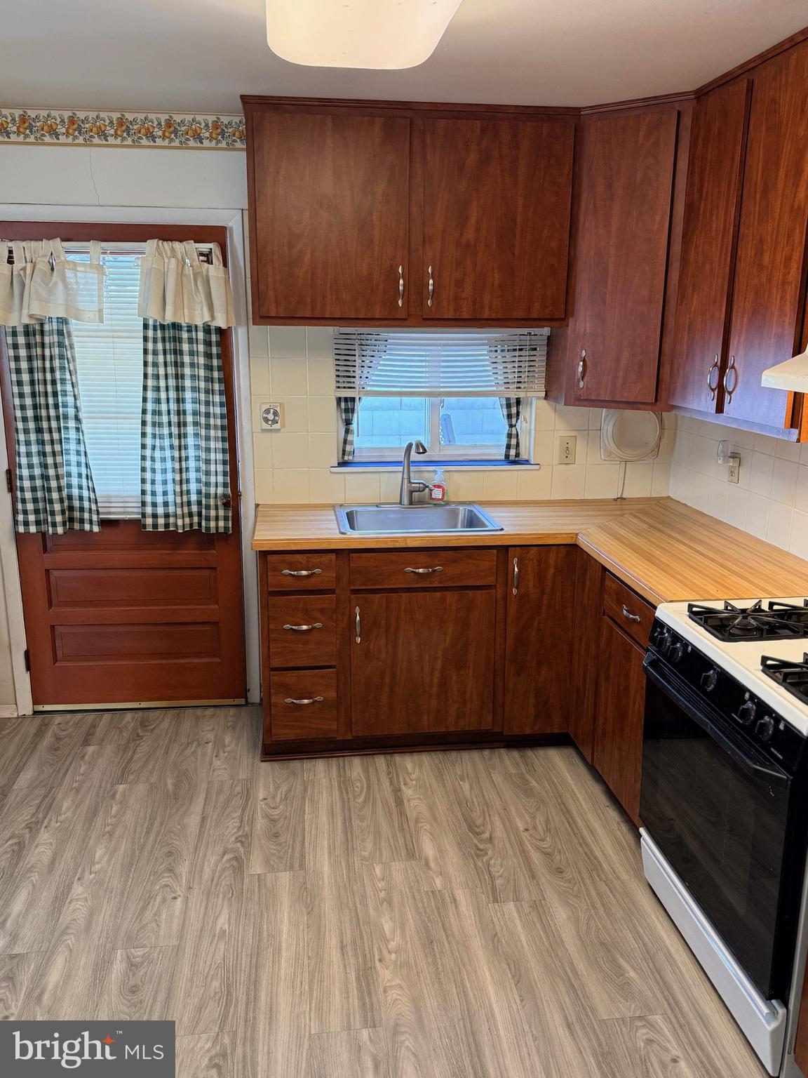 1446 Fitzwatertown Road Willow Grove, PA 19090 - Photo 9 of 19 a kitchen with stainless steel appliances granite countertop a sink stove and cabinets