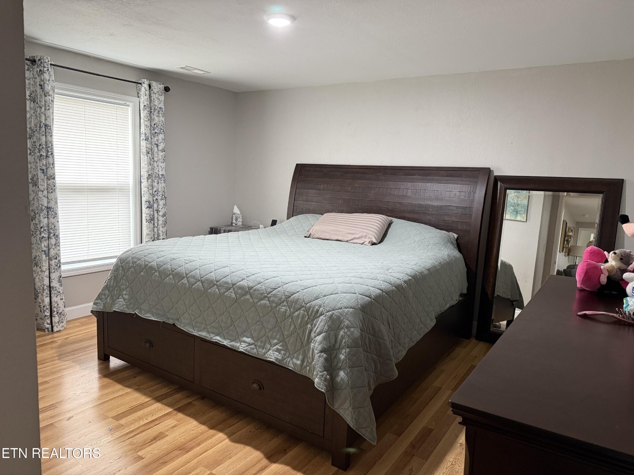 309 Hobson Road Kingston, TN 37763 - Photo 8 of 12 a large bed sitting in a bedroom next to a window