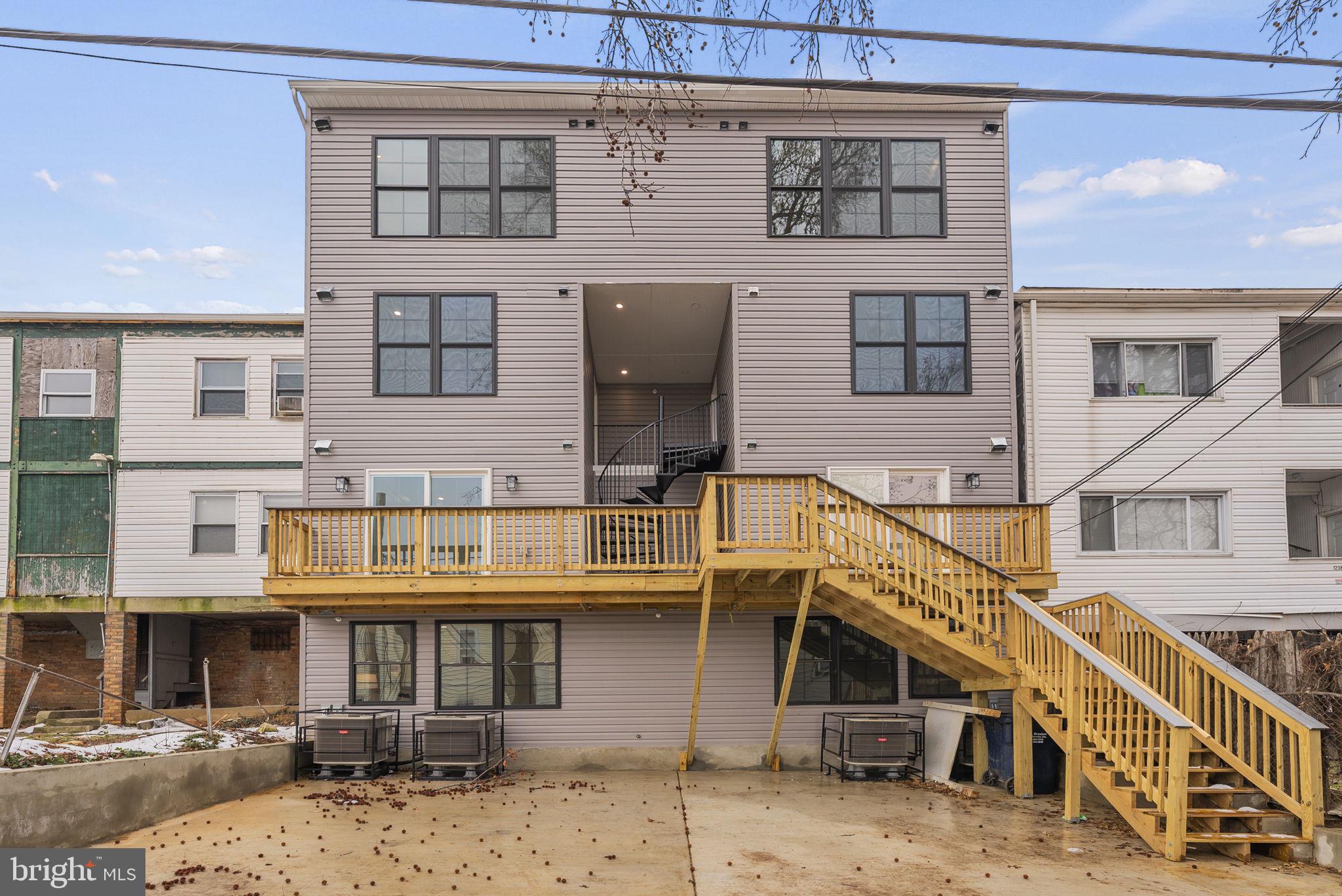 1242 Meigs Place Northeast, Unit 3 Washington, DC 20002 - Photo 13 of 13 a front view of a building with streets and trees