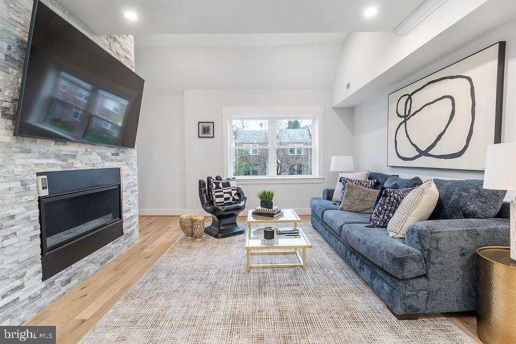1242 Meigs Place Northeast, Unit 3 Washington, DC 20002 - Photo 3 of 13 a living room with furniture a flat screen tv and a fireplace