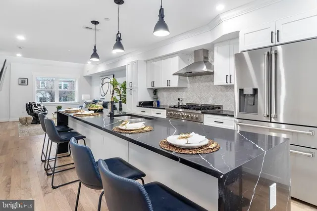 a kitchen with a table chairs stove and refrigerator