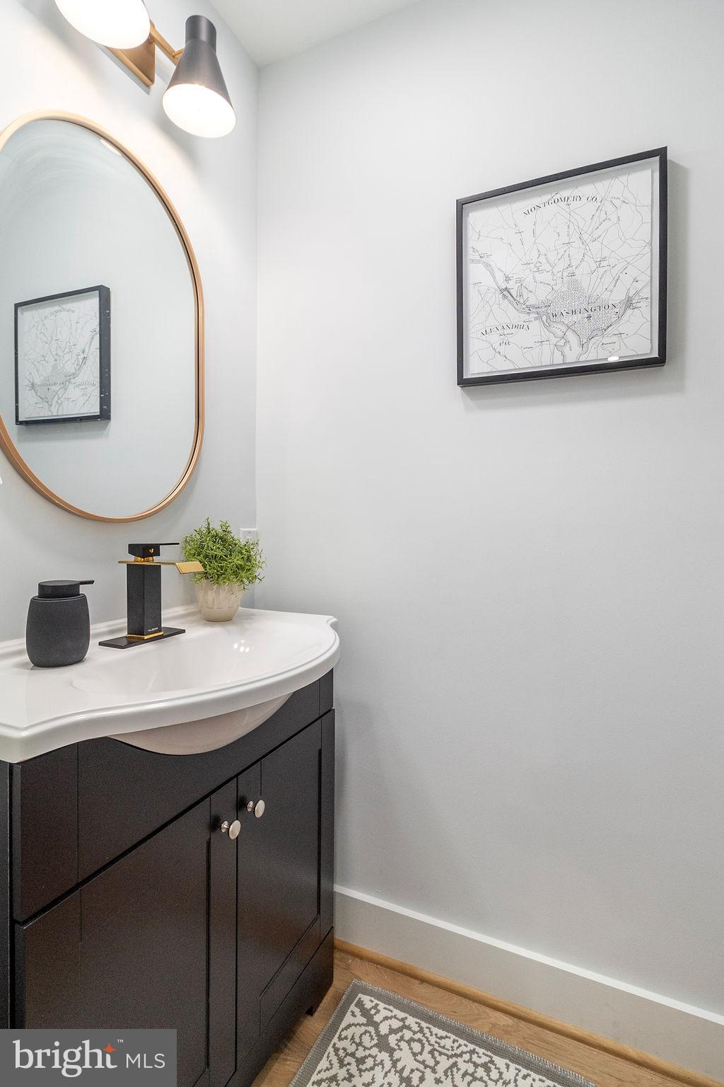 1242 Meigs Place Northeast, Unit 3 Washington, DC 20002 - Photo 8 of 13 a bathroom with a sink and a mirror