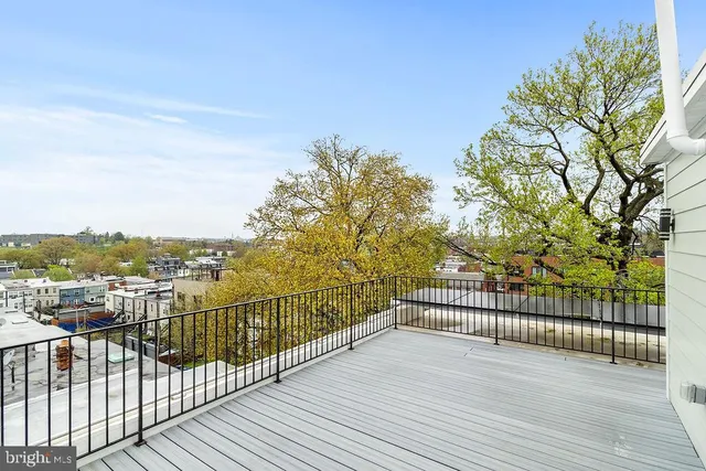 a view of a balcony with wooden fence