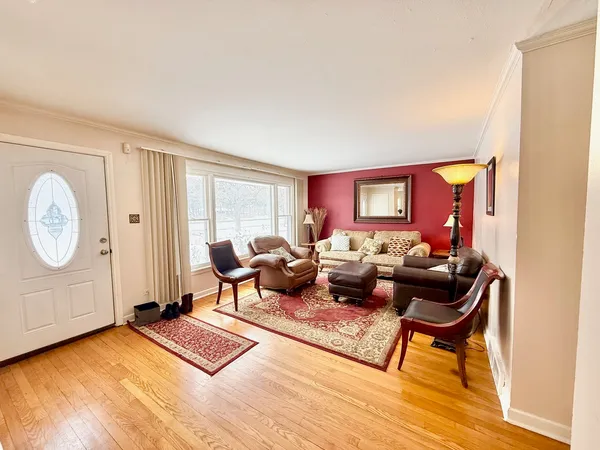 a living room with furniture a rug and a window