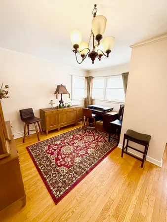a living room with dining table and a large window
