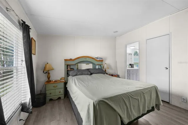 a bedroom with a bed and a dresser