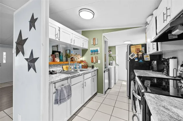 a kitchen with stainless steel appliances granite countertop a sink and cabinets