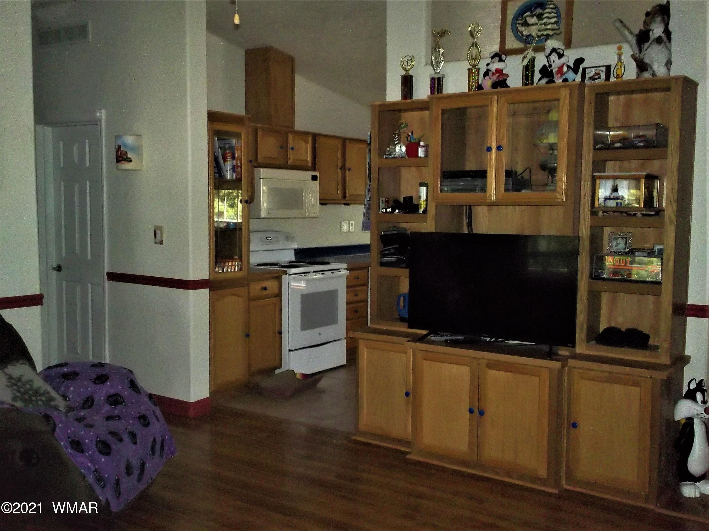 6 N3097 Vernon, AZ 85940 - Photo 13 of 40 a kitchen with stainless steel appliances kitchen island granite countertop a refrigerator and a stove top oven