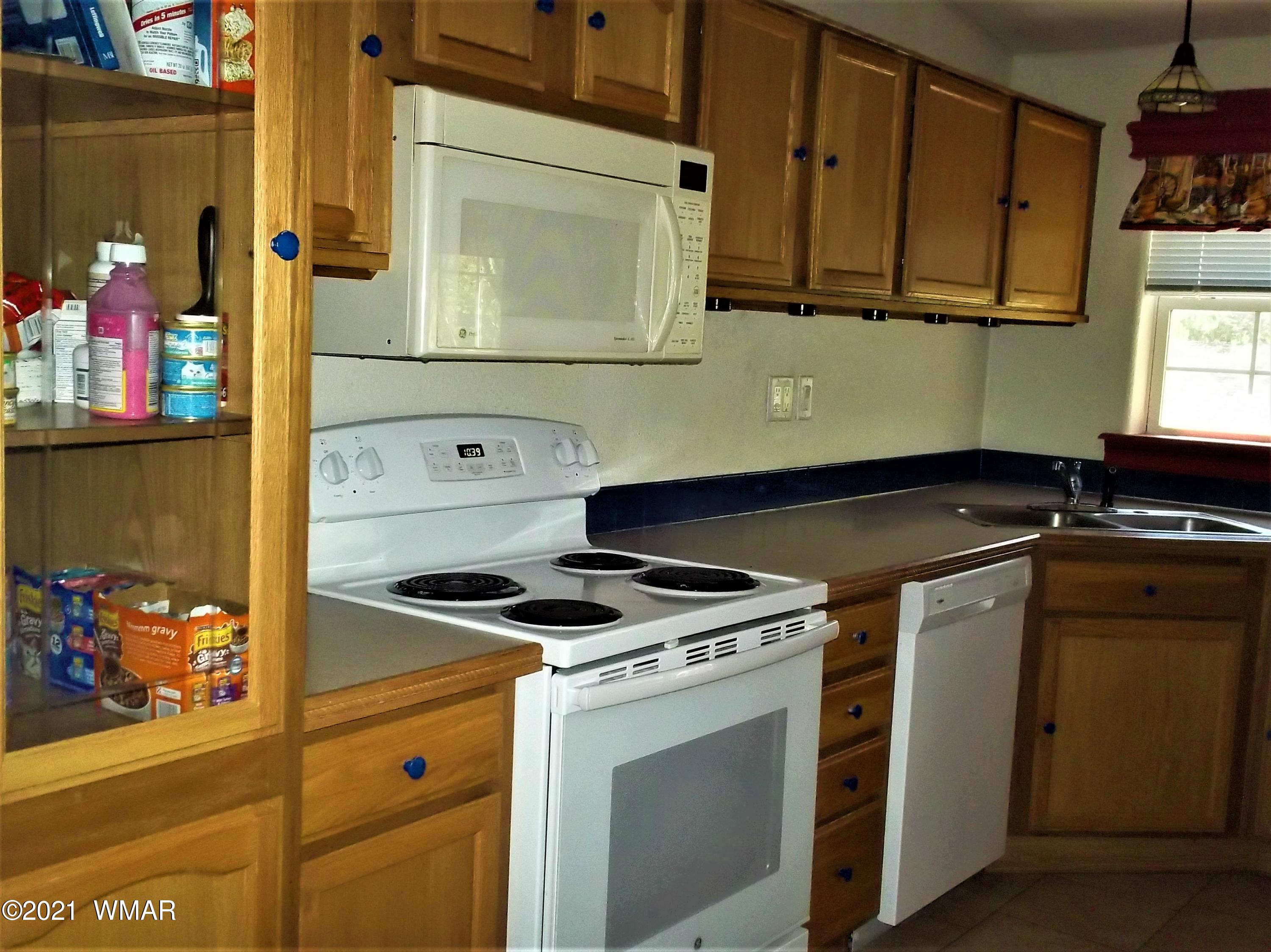 6 N3097 Vernon, AZ 85940 - Photo 17 of 40 a kitchen with stainless steel appliances granite countertop a stove and a microwave