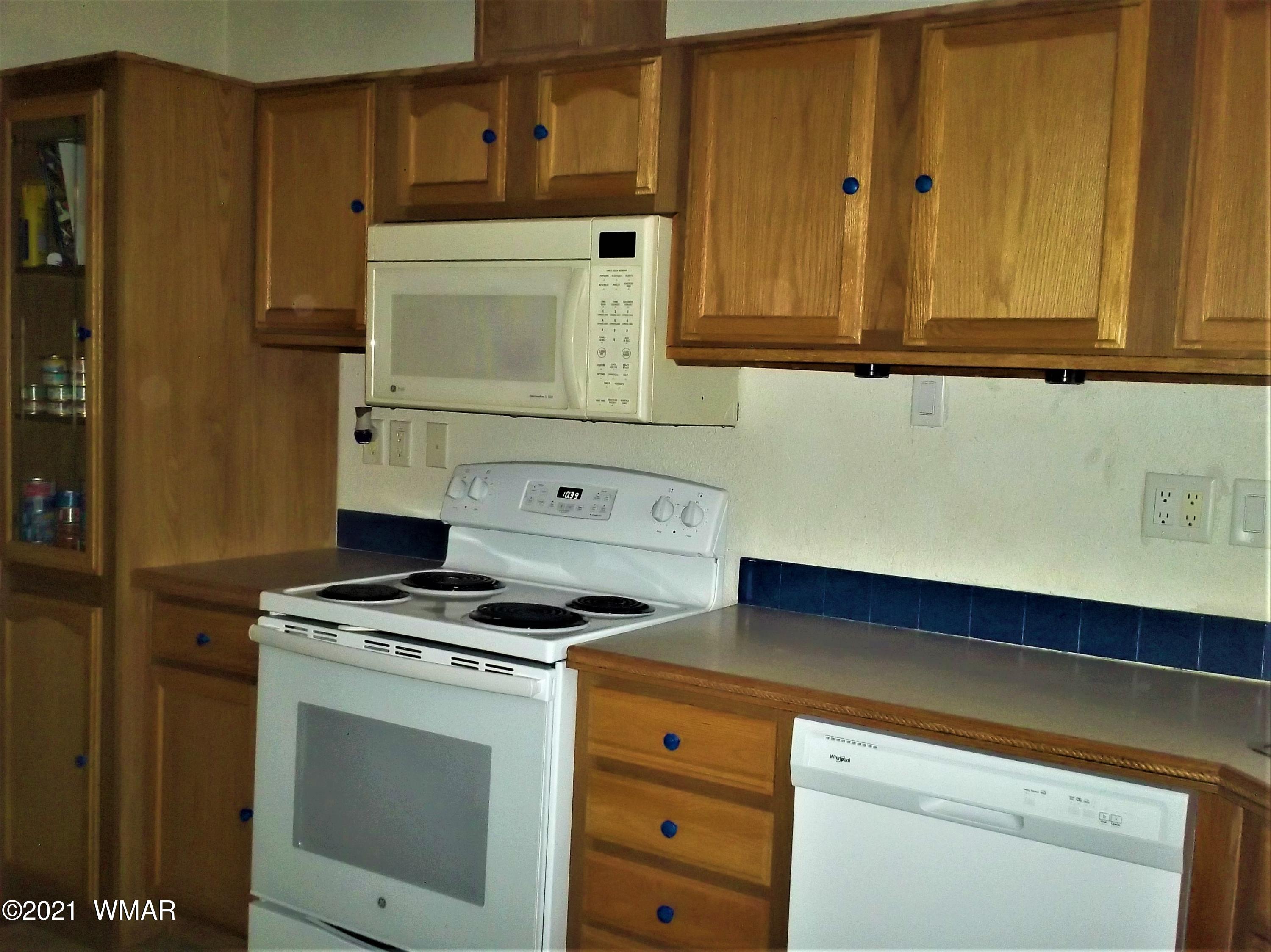 6 N3097 Vernon, AZ 85940 - Photo 18 of 40 a kitchen with granite countertop cabinets and white appliances