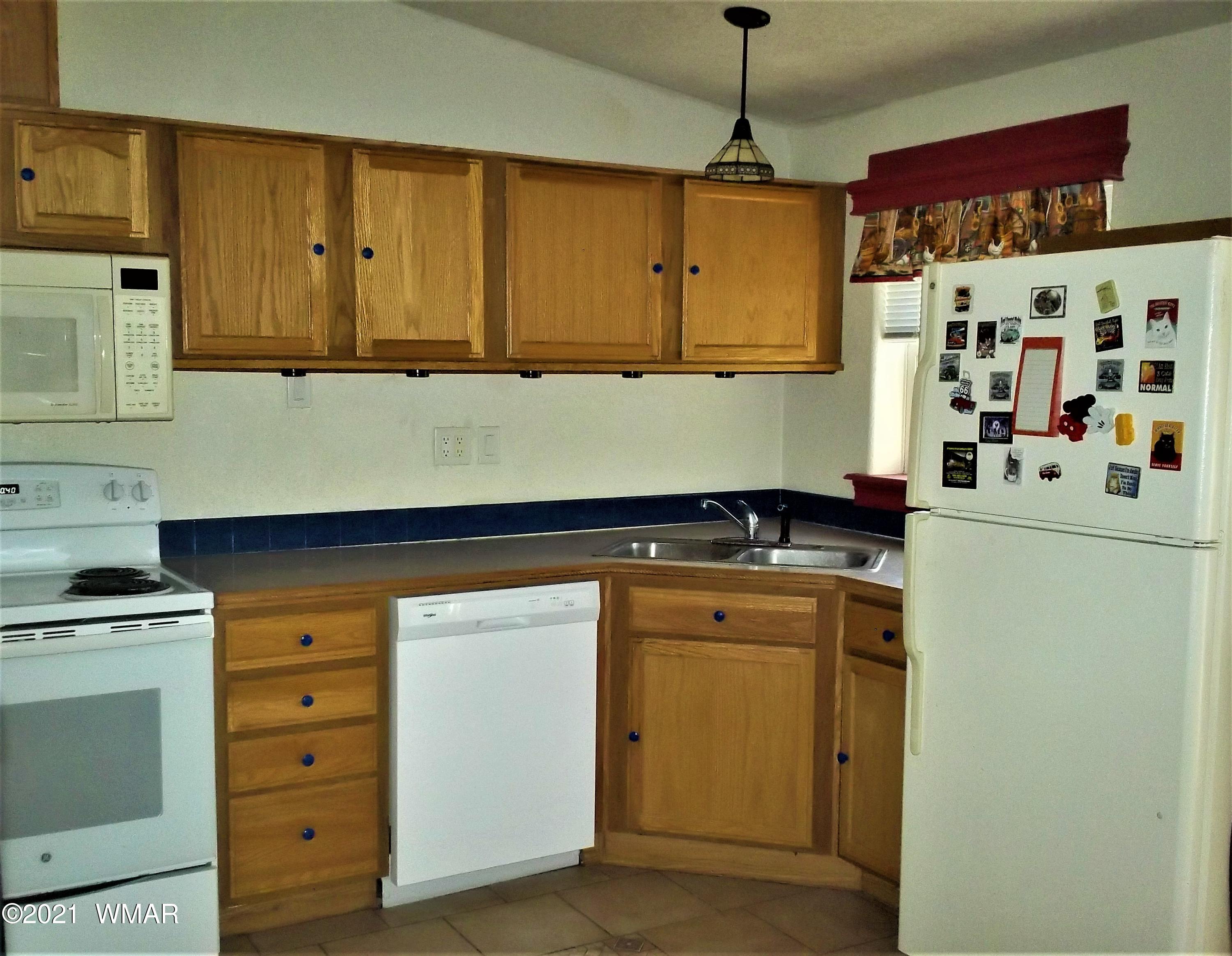 6 N3097 Vernon, AZ 85940 - Photo 19 of 40 a kitchen with cabinets appliances and a window