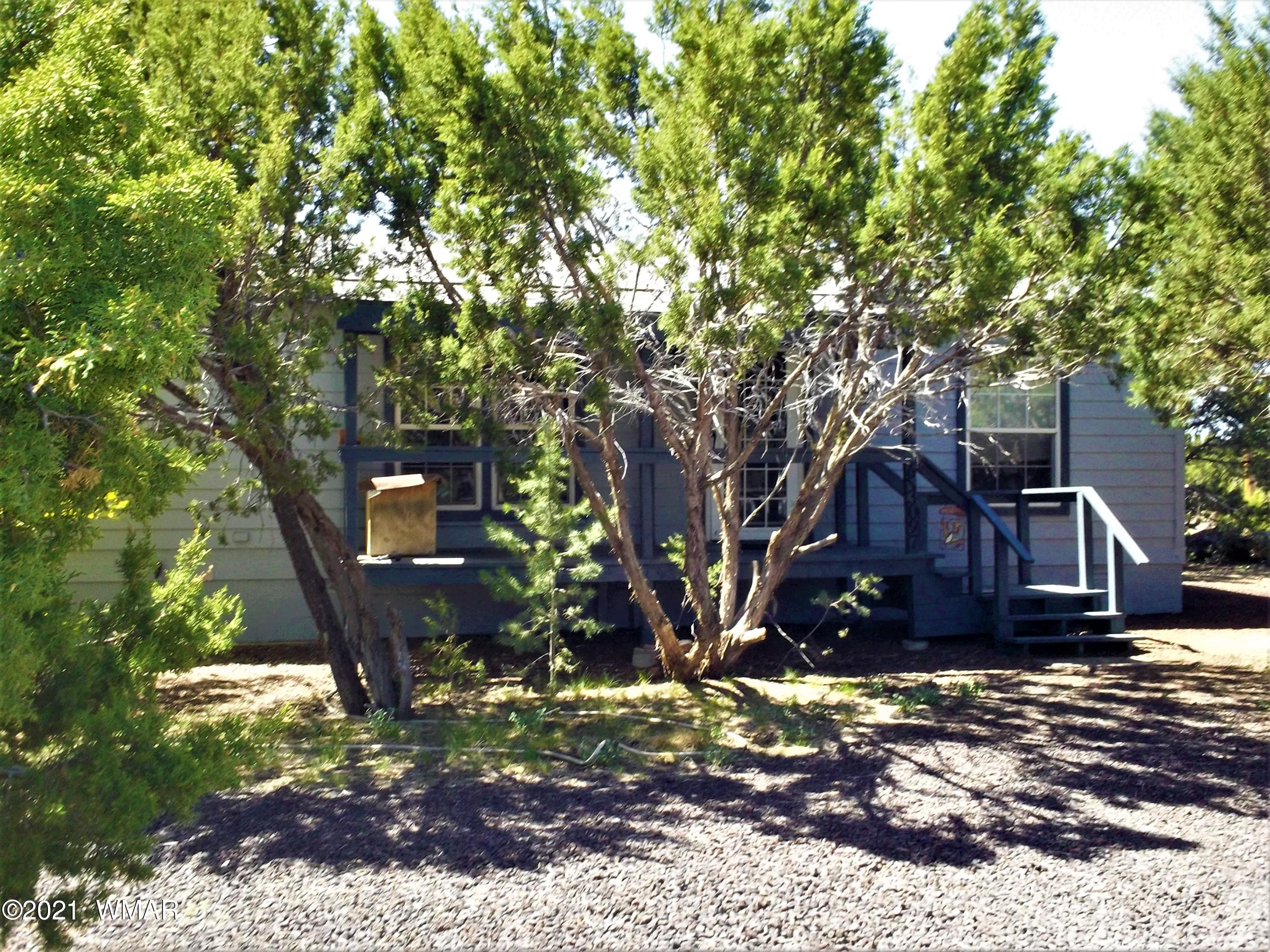 6 N3097 Vernon, AZ 85940 - Photo 3 of 40 a wooden bench sitting in front of a tree