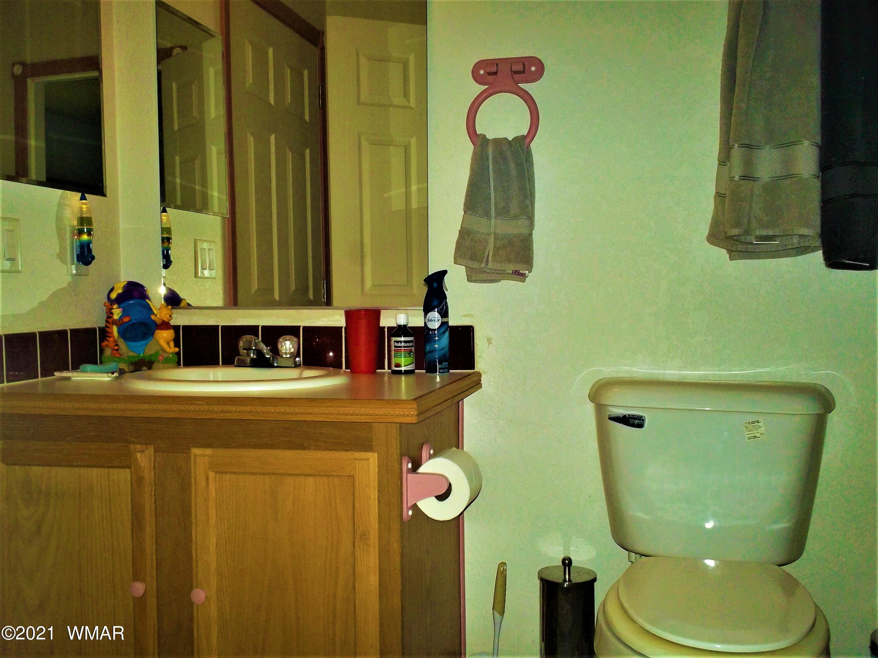 6 N3097 Vernon, AZ 85940 - Photo 33 of 40 a bathroom with a toilet sink and mirror