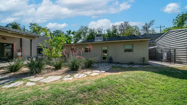 a large kitchen with stainless steel appliances granite countertop a refrigerator and a stove top oven