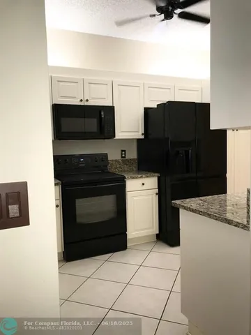 a kitchen with stainless steel appliances a stove a microwave and a refrigerator
